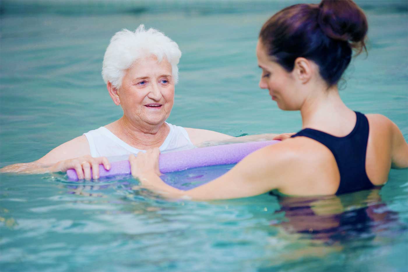 A man and woman swimming in the water